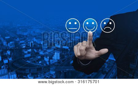 Businessman Pressing Excellent Smiley Face Rating Icon Over Modern City Tower, Street, Expressway An