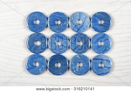 Twelve Dumortierite Round Donut-shaped Stones Are Stowed Three Rows. Four Pieces In Each One. Top Vi