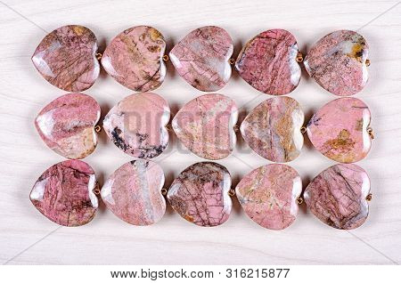 Fifteen Rose-pink Rhodonite Heart-shaped Stones Are Stowed Three Rows. Five Pieces In Each One. Top 