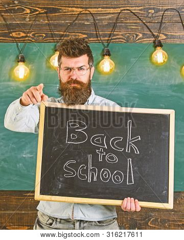 Back To School Concept. Teacher In Eyeglasses Holds Blackboard With Inscription Back To School. Man 