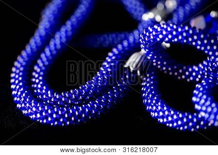 Long Open Necklace (lariat) Blue Color On A Dark Background Close Up