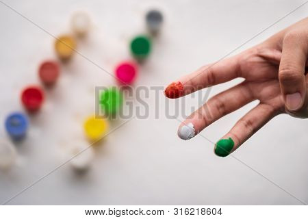 Indian Girl Showing Her Painted Tricolor Fingers, Top View Isolated Over White Background.