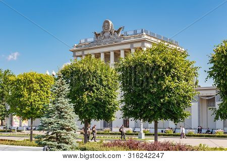 Moscow, Russia - July 22, 2019: Pavilion Optics On Vdnh In Moscow Against Blue Sky And Green Trees A