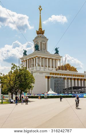 Moscow, Russia - July 22, 2019: People Walking On Alleys Against Pavilion Ussr In Vdnh Park In Mosco
