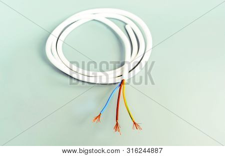 Three-core Cable In White Isolation On A Gray Background
