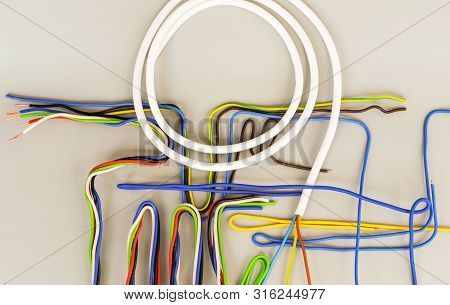The Wires Of Several Types In Colored Insulation Are Curved In Different Shapes On A Gray Background
