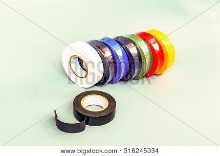 Set Of Multicolored Insulating Tapes On Gray Background