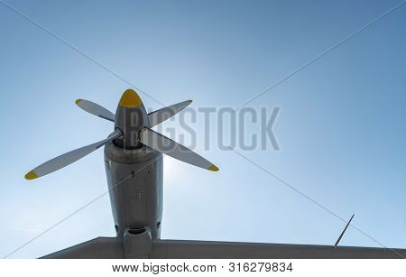 Airplane Propeller Of Military Aircraft, Copy Space. Blue Sky Sunny Background.