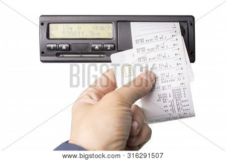 Digital Tachograph And Drivers Hand Holding Print With Driving Times Of The Day. Isolated On White B
