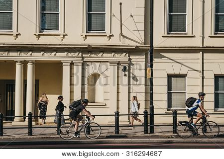 London, Uk - July 16, 2019: People Cycling On A Street In Pimlico, London, During Golden Hour, Selec