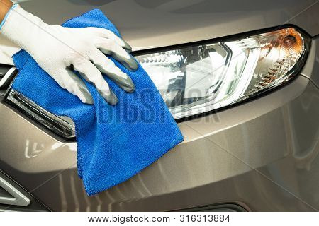 Hand Cleaning Car With Blue Micro-fiber Cloth.