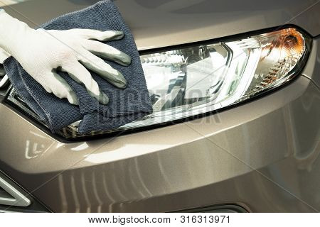 Hand Cleaning Car With Blue Micro-fiber Cloth.