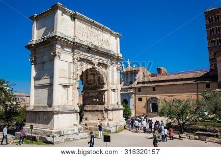 Rome, Italy - April, 2018: Tourists At The Arch Of Constantine A Triumphal Arch In Rome, Situated Be