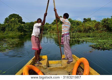 Boatmen Drive Boat Through Buxa Tiger Reserve In West Bengal, India. A Boat Ride Through The Jungle.