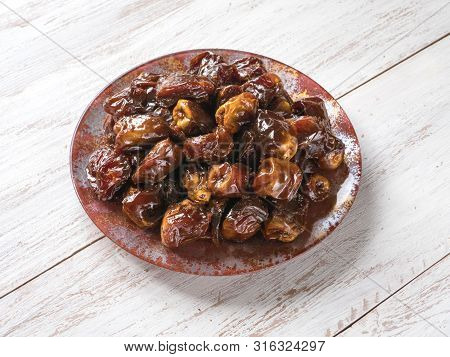 Delicious Organic Sweet Dates In Bowl With Syrup. Iftar Dates.