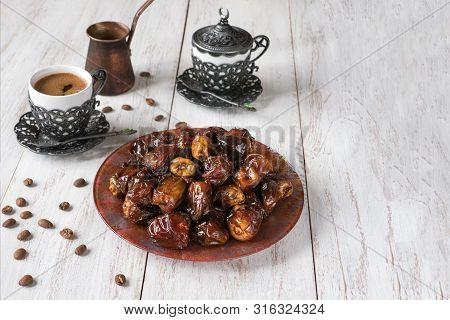 Organic Sweet Dates With Syrup And Black Coffee. Ramadan Kareem Holiday Concept.