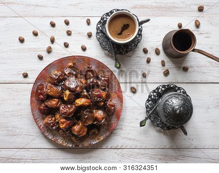 Organic Sweet Dates With Syrup And Black Coffee. Ramadan Kareem Holiday Concept.