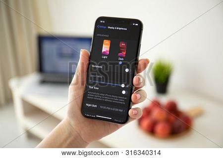 Anapa, Russia - July 21, 2019: Woman Hand Holding Iphone X With Ios 13 And Dark Mode Settings. Iphon