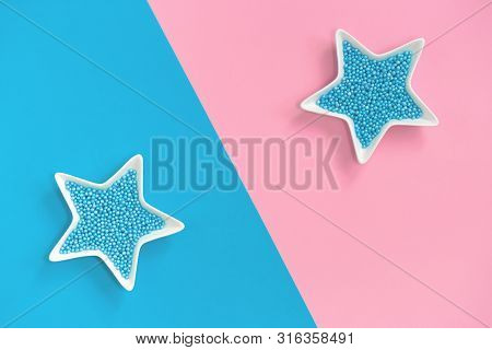 Blue Nonpareils Cake Candy Sprinkles In Two White Star Bowls On Pink Blue Background In Flat Lay Wit