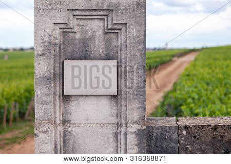 Closeup Vintage Rectangular Shape Stone Aged Plate, Nameboard On A Gray Textured Wall. Concept Place