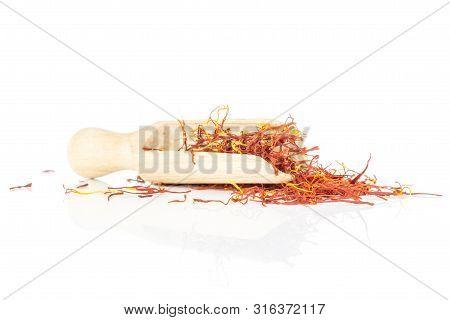 Lot Of Whole Dry Shaffron Thread With Wooden Scoop Isolated On White Background