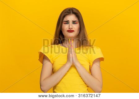 Beautiful Young Lady In A Casual Clothing Holding Hands Expressing Emotion Of Pleading For Apologize