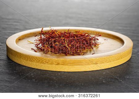 Lot Of Whole Dry Shaffron Thread On Bamboo Plate On Grey Stone