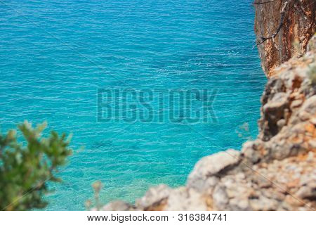Beautiful Sandy Beach With Rock And Blue Clear Water
