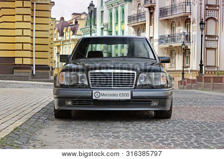Kiev, Ukraine - September 6, 2013: Mercedes E500 W124 Wolf On The Background Of Beautiful Old Houses