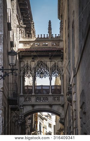 Pont Del Bisbe And Narrow Street In Gothic Quarter In Barcelona Spain