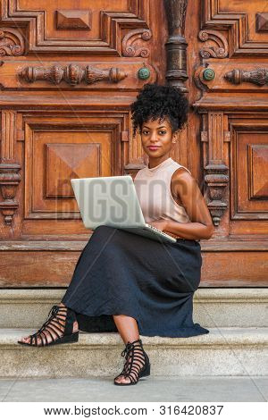 African American Student Studying In New York, With Afro Hairstyle, Wearing Sleeveless Light Color T