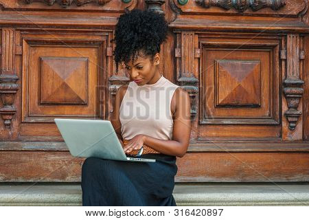 Way To Success. Young African American Woman With Afro Hairstyle Wearing Sleeveless Light Color Top,