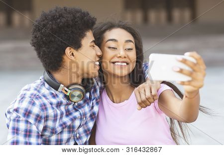 Capturing Happy Moments. Closeup Of Joyful Young Couple Making Selfie On Smartphone Camera While Sta