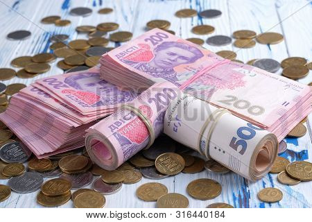 Bundles Ukrainian Banknotes Value Of 200 And 500 Hryvnia Uah And Pile Of Coins.