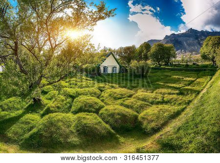 Picturesque View Of  Turf-top Church Hofskirkja During Sunset. Location: Village Of Hof, Skaftafell,