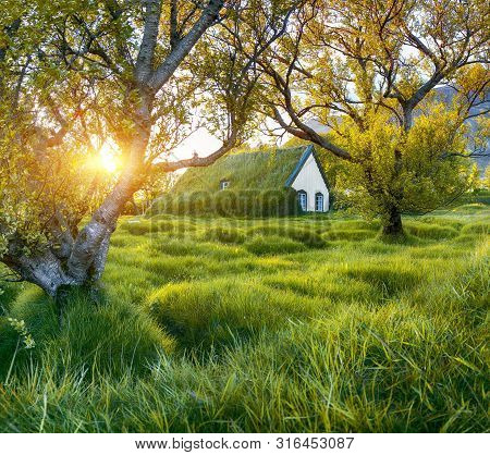 Picturesque View Of  Turf-top Church Hofskirkja During Sunset. Location: Village Of Hof, Skaftafell,