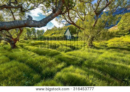 Picturesque View Of  Turf-top Church Hofskirkja During Sunset. Location: Village Of Hof, Skaftafell,