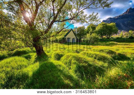 Picturesque View Of  Turf-top Church Hofskirkja During Sunset. Location: Village Of Hof, Skaftafell,