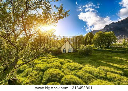 Picturesque View Of  Turf-top Church Hofskirkja During Sunset. Location: Village Of Hof, Skaftafell,