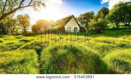 Picturesque View Of  Turf-top Church Hofskirkja During Sunset. Location: Village Of Hof, Skaftafell,