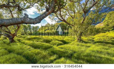 Picturesque View Of  Turf-top Church Hofskirkja During Sunset. Location: Village Of Hof, Skaftafell,