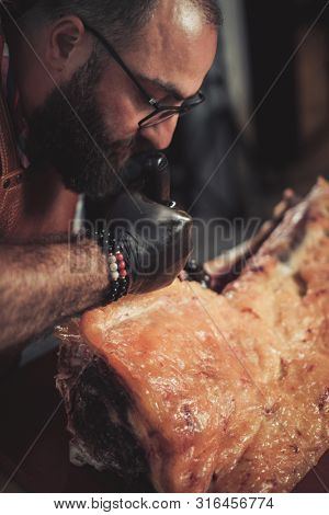 Chef cutting beef carcass in a restaurant
