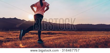 Asian Woman Enjoys Running Outside With Beautiful Summer Evening In The Countryside.