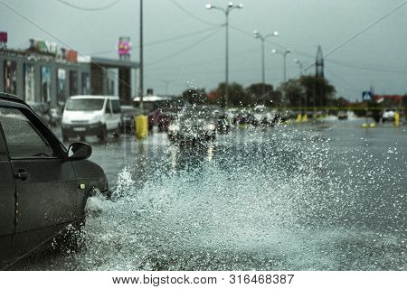 Driving Car On Flooded Road During Flood Caused By Torrential Rains. Cars Float On Water, Flooding S