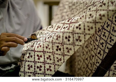August 11 2019, Surakarta Indonesia : Close Up Hand To Make Batik On The Fabric With Canting With Bo
