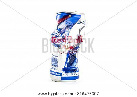 Sankt-petersburg, Russia - August 08, 2019:  Crumpled Aluminum Can Of Redbull Drink Over White Backg