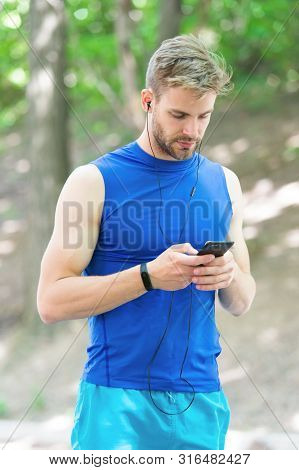 Training With Sport Application Is More Fun. Set Up Application. Sportsman With Smartphone And Smart