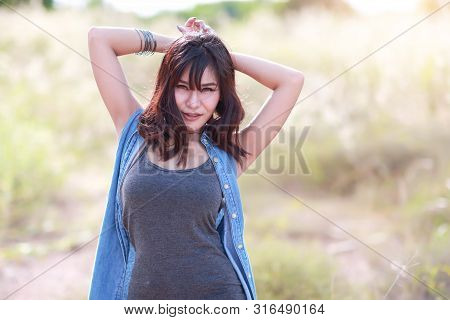 Young And Cute Girl Having A Happy Time And Enoying Amoung Grass Field In Nature