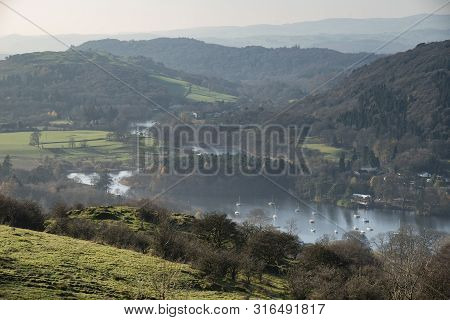 Beautiful Autumn Fall Landscape Image Of View From Gummers How Down Onto Derwent Wter In Lake Distri