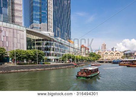 Singapore - July 8th 2019: The Singapore River At Clarke Quay. The River Flows Through The City Cent